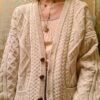 vintage knitted cardigan half buttoned in creamy color