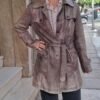 vintage leather trenchcoat in adistressed brown tone features waist belt, large flap pockets and shoulder epaulettes