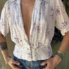 vintage white printed top with fitted waist, pleats and deep V neck
